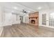 Open living room features a brick fireplace and hardwood floors at 781 Summerwood Dr, Rock Hill, SC 29732