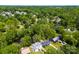 Overhead view of a neighborhood with mature trees, ponds, and well-maintained homes on spacious lots at 7905 Quail Field Dr, Charlotte, NC 28227