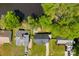 Aerial view of a home nestled near a serene lake and surrounded by lush greenery and neighboring houses at 7905 Quail Field Dr, Charlotte, NC 28227
