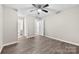 Spacious bedroom featuring new flooring and multiple doorways at 7905 Quail Field Dr, Charlotte, NC 28227