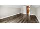 Bright bedroom featuring fresh paint, an open door, and hardwood flooring at 7905 Quail Field Dr, Charlotte, NC 28227