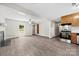 Open-concept living space with neutral tones, hardwood floors, fireplace, and a view into the kitchen at 7905 Quail Field Dr, Charlotte, NC 28227