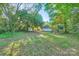 Large backyard with mature trees, a play structure, and shed for additional storage at 828 Richard Ave, Kannapolis, NC 28081
