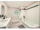 Modern bathroom featuring double vanity, tiled walls, and black hardware at 828 Richard Ave, Kannapolis, NC 28081