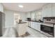 Updated kitchen features an island, stainless appliances, and tile backsplash at 828 Richard Ave, Kannapolis, NC 28081