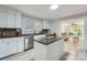Well-lit kitchen with granite countertops and an island, open to the living room at 828 Richard Ave, Kannapolis, NC 28081