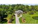 Stunning aerial view of the home with lush landscaping and a circular driveway at 8670 Arbor Oaks Cir, Concord, NC 28027