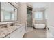 Bathroom with granite counters, glass shower, and a free standing soaking tub at 8670 Arbor Oaks Cir, Concord, NC 28027