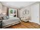 Bedroom with hardwood flooring, a comfortable couch, and natural light from an outside view at 8670 Arbor Oaks Cir, Concord, NC 28027