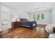 Spacious bedroom with a trey ceiling, hardwood floors, and large windows with plantation shutters at 8670 Arbor Oaks Cir, Concord, NC 28027