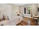 Cozy bedroom with hardwood floors, large window, and ample natural light at 8670 Arbor Oaks Cir, Concord, NC 28027