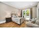 Comfortable bedroom featuring hardwood floors, a cozy couch, and double doors to the outside at 8670 Arbor Oaks Cir, Concord, NC 28027