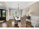 Formal dining room with hardwood floors, chandelier, and wainscoting at 8670 Arbor Oaks Cir, Concord, NC 28027