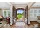 Elegant foyer with hardwood floors, stone accents, and a view of the landscaped front yard at 8670 Arbor Oaks Cir, Concord, NC 28027