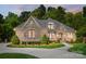 Beautiful exterior of the home with stone and brick accents and manicured landscaping at 8670 Arbor Oaks Cir, Concord, NC 28027