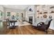 Bright living room featuring fireplace, built-in shelves, and hardwood floors at 8670 Arbor Oaks Cir, Concord, NC 28027