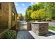 Outdoor kitchen with built-in grill, stone countertop, and stainless steel storage at 8670 Arbor Oaks Cir, Concord, NC 28027