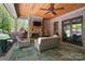 Covered patio area with stone fireplace, wood ceiling and ceiling fan, perfect for relaxing outdoors at 8670 Arbor Oaks Cir, Concord, NC 28027