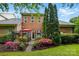 Beautiful brick home exterior with a manicured backyard, garden, and patio at 9652 Wheatfield Rd, Charlotte, NC 28277
