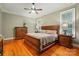 Spacious bedroom with hardwood floors, a ceiling fan, and a decorative dresser and two windows with shutters at 9652 Wheatfield Rd, Charlotte, NC 28277
