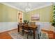 Traditional dining room with a wooden table, a decorative rug, and a view of the kitchen at 9652 Wheatfield Rd, Charlotte, NC 28277