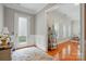 Inviting entryway with hardwood floors, white wainscoting, and a decorative rug and furniture at 9652 Wheatfield Rd, Charlotte, NC 28277