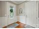 Inviting foyer featuring hardwood floors, paneled walls, and a decorative front door with leaded glass at 9652 Wheatfield Rd, Charlotte, NC 28277