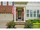 Charming front porch featuring flowers, stylish lighting, and a classic black door with glass details at 9652 Wheatfield Rd, Charlotte, NC 28277