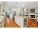 Spacious kitchen with an island, wine storage, stainless steel appliances, and hardwood floors, open to the living area at 9652 Wheatfield Rd, Charlotte, NC 28277