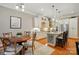 Bright kitchen with an island and seating, featuring hardwood floors, stainless steel appliances, and pendant lighting at 9652 Wheatfield Rd, Charlotte, NC 28277