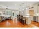 Open-concept living room showcasing hardwood floors, a kitchen island with seating, and a stylish seating area at 9652 Wheatfield Rd, Charlotte, NC 28277