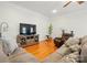 Relaxing living room features a gray sectional, a recliner chair, hardwood floors, and a large television at 9652 Wheatfield Rd, Charlotte, NC 28277