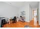 Functional office space with desk, shelving, hardwood floors and neutral colored walls at 9652 Wheatfield Rd, Charlotte, NC 28277