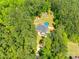 Aerial view of home showcasing its treed lot, proximity to nature, and above ground pool at 1006 Chambers Rd, York, SC 29745