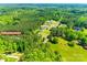 Aerial view illustrating the home's location within a peaceful neighborhood surrounded by lush greenery and trees at 1006 Chambers Rd, York, SC 29745