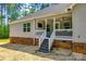 Exterior view of a home featuring an inviting deck with stairs, neutral siding and brick foundation at 1006 Chambers Rd, York, SC 29745