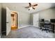 Cozy bedroom featuring a ceiling fan, plush carpet, and an adjacent bathroom at 1006 Chambers Rd, York, SC 29745