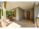 Inviting front porch with wooden rocking chairs and table next to stained wood front door at 1006 Chambers Rd, York, SC 29745