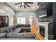 Open-concept living room showcasing hardwood flooring, a fireplace, large sectional, and black ceiling fan at 1006 Chambers Rd, York, SC 29745