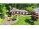 Overhead view of a charming brick house with lush lawns and landscaping, surrounded by mature trees at 1024 Regency Dr, Charlotte, NC 28211