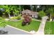 Aerial view of the brick home with a well-kept lawn and mature trees, plus a driveway at 1024 Regency Dr, Charlotte, NC 28211
