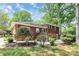 A well-manicured backyard features lush landscaping, a patio area, and a brick home exterior at 1024 Regency Dr, Charlotte, NC 28211