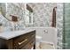 Charming bathroom features patterned wallpaper, a modern vanity, and marble floors at 1024 Regency Dr, Charlotte, NC 28211