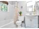 Bathroom featuring a shower/tub, window and floral shower curtain at 1024 Regency Dr, Charlotte, NC 28211