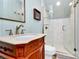 Bathroom featuring a wood vanity with marble countertop, glass shower, and tile floors at 1024 Regency Dr, Charlotte, NC 28211