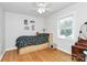 Bright bedroom featuring hardwood floors, a ceiling fan, and a window with blinds for natural light at 1024 Regency Dr, Charlotte, NC 28211