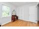 Bedroom featuring hardwood floors, a window with blinds, a closet, and a vintage vanity at 1024 Regency Dr, Charlotte, NC 28211