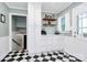 Charming kitchen with black and white tile floor, white cabinets and shelves at 1024 Regency Dr, Charlotte, NC 28211