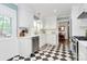 Well-lit kitchen featuring white cabinets, stainless steel appliances, and checkered flooring at 1024 Regency Dr, Charlotte, NC 28211