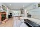 Open living room with fireplace, French doors, built-in bookshelves, and neutral decor at 1024 Regency Dr, Charlotte, NC 28211